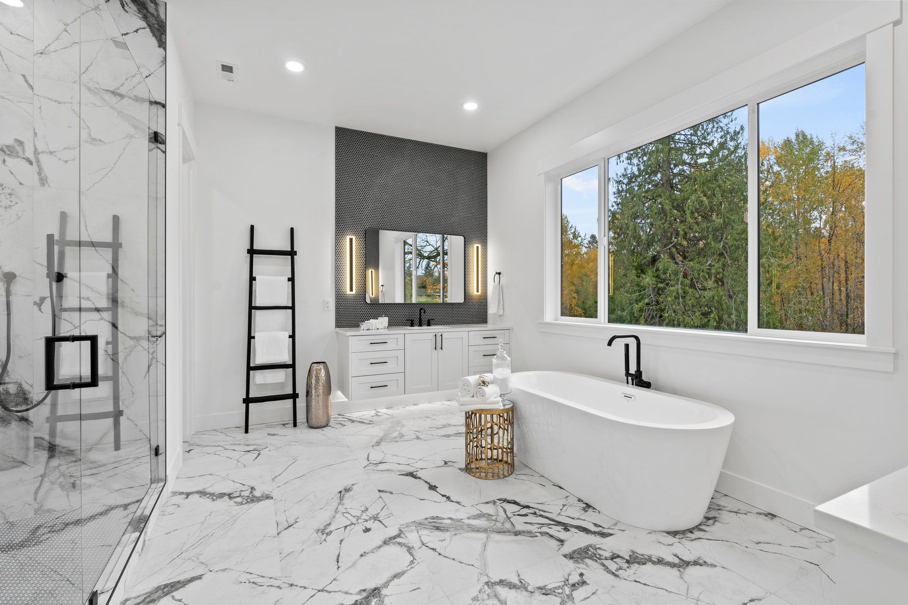 A bathroom with a tub , shower , sink and window.