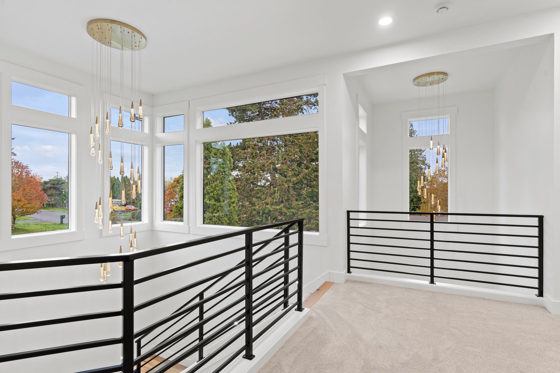 There is a balcony in the middle of the room with a black railing.