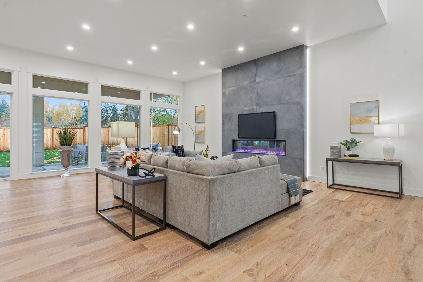 A living room with a couch , fireplace and television.