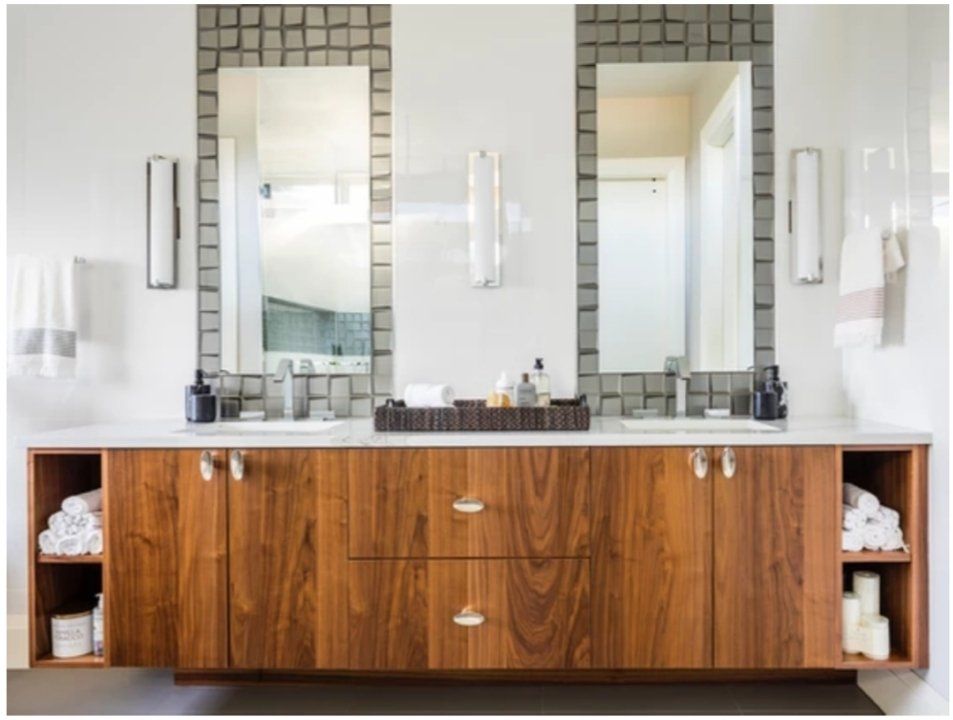 A bathroom with two sinks and two mirrors