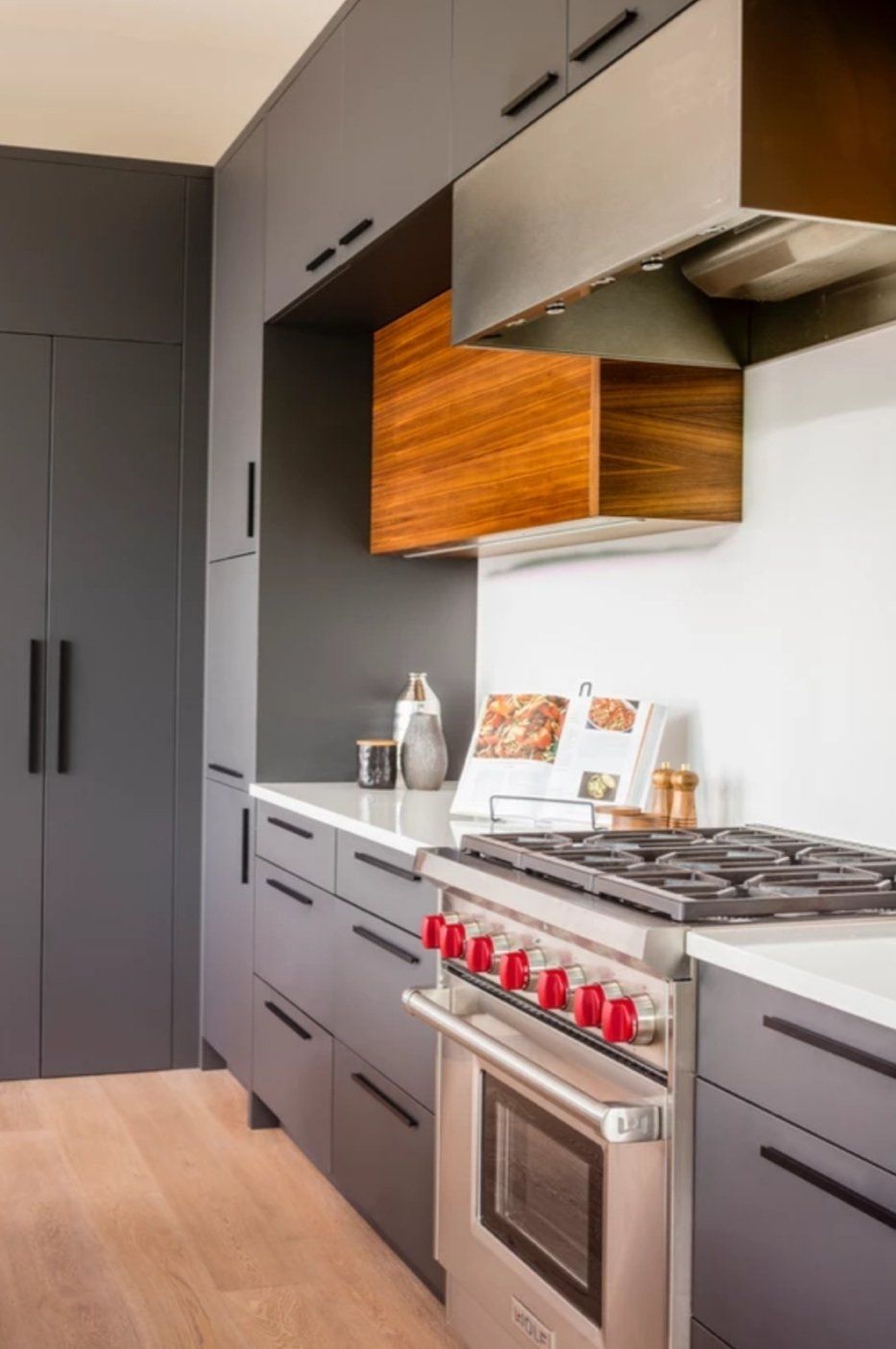 A kitchen with a stove , oven , and refrigerator.
