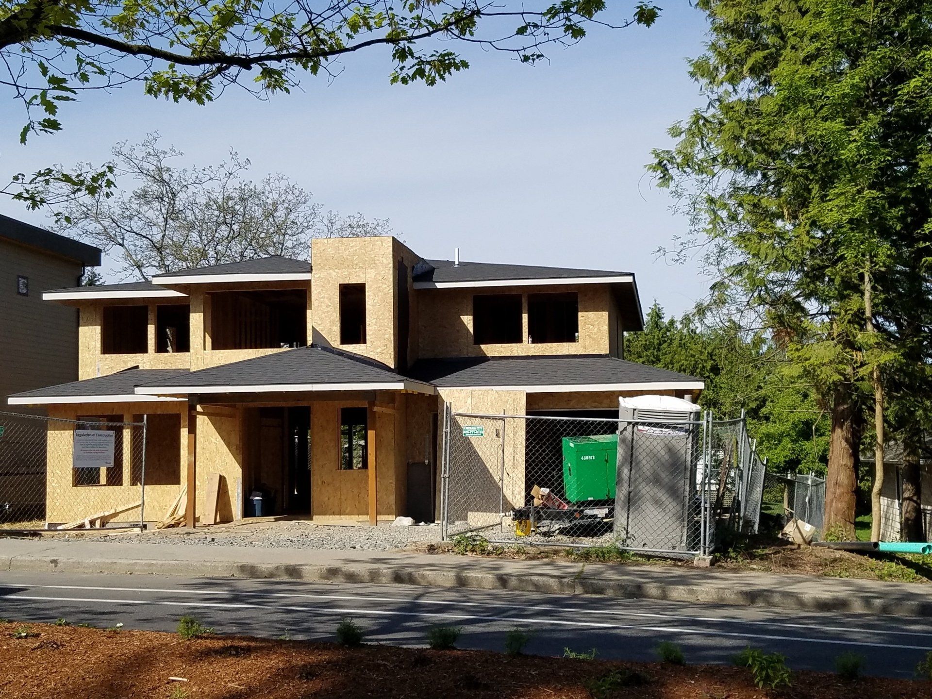 A house under construction with a fence around it