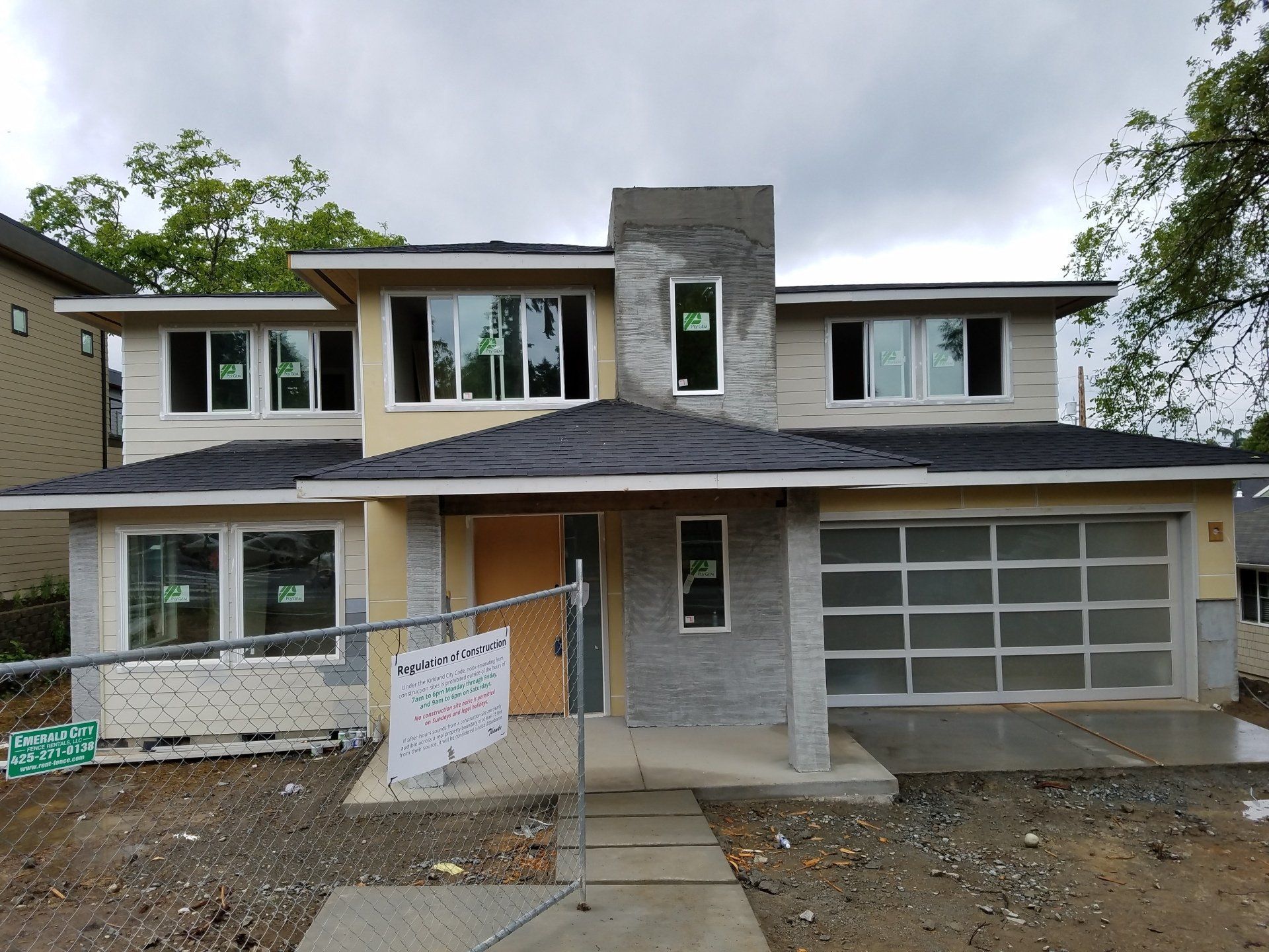 A house that is being built with a sign that says ' for sale ' on it