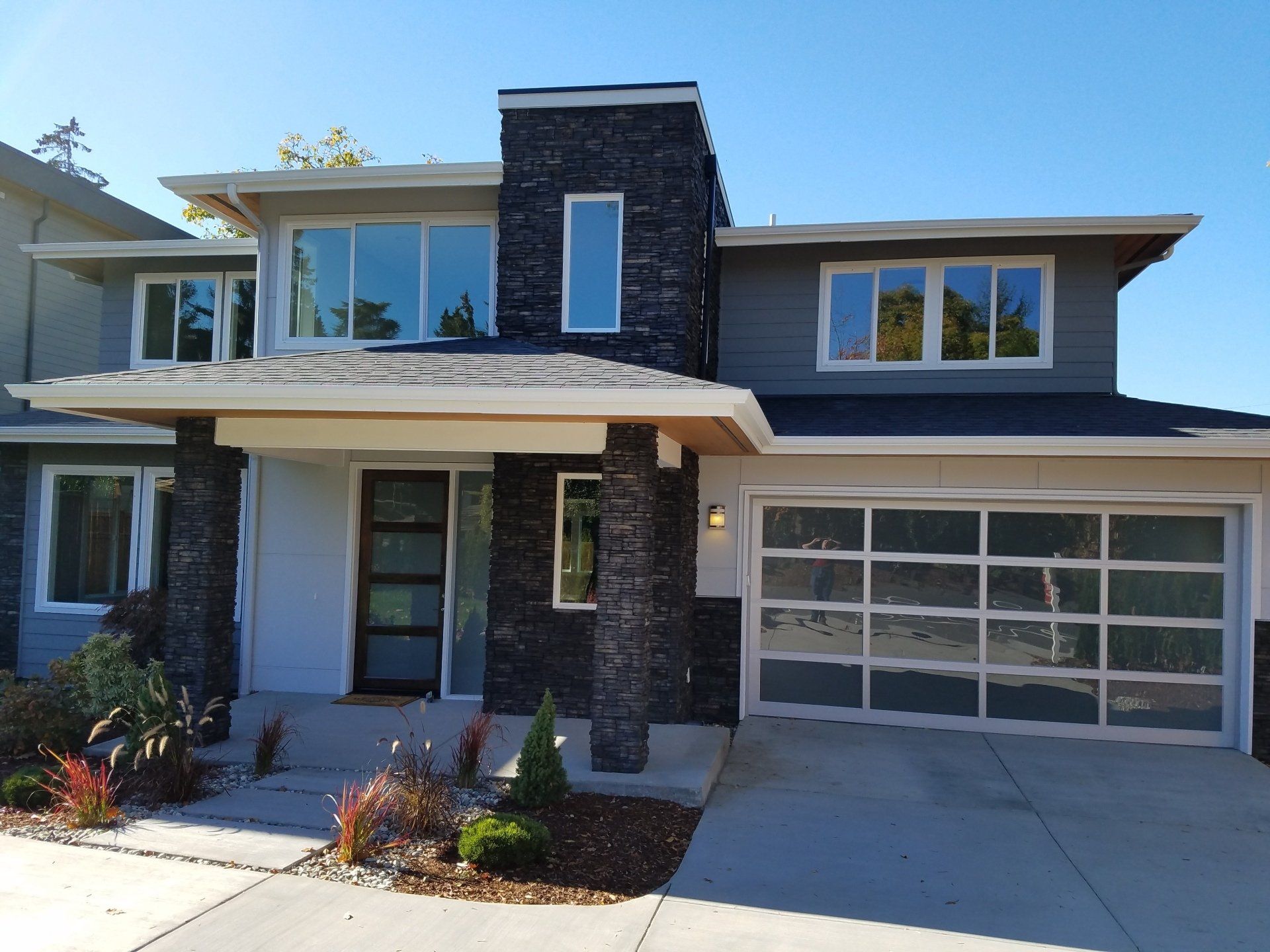 A large house with a garage and a lot of windows