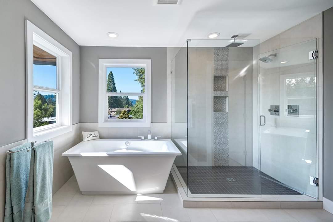 A bathroom with a bathtub and a walk in shower.
