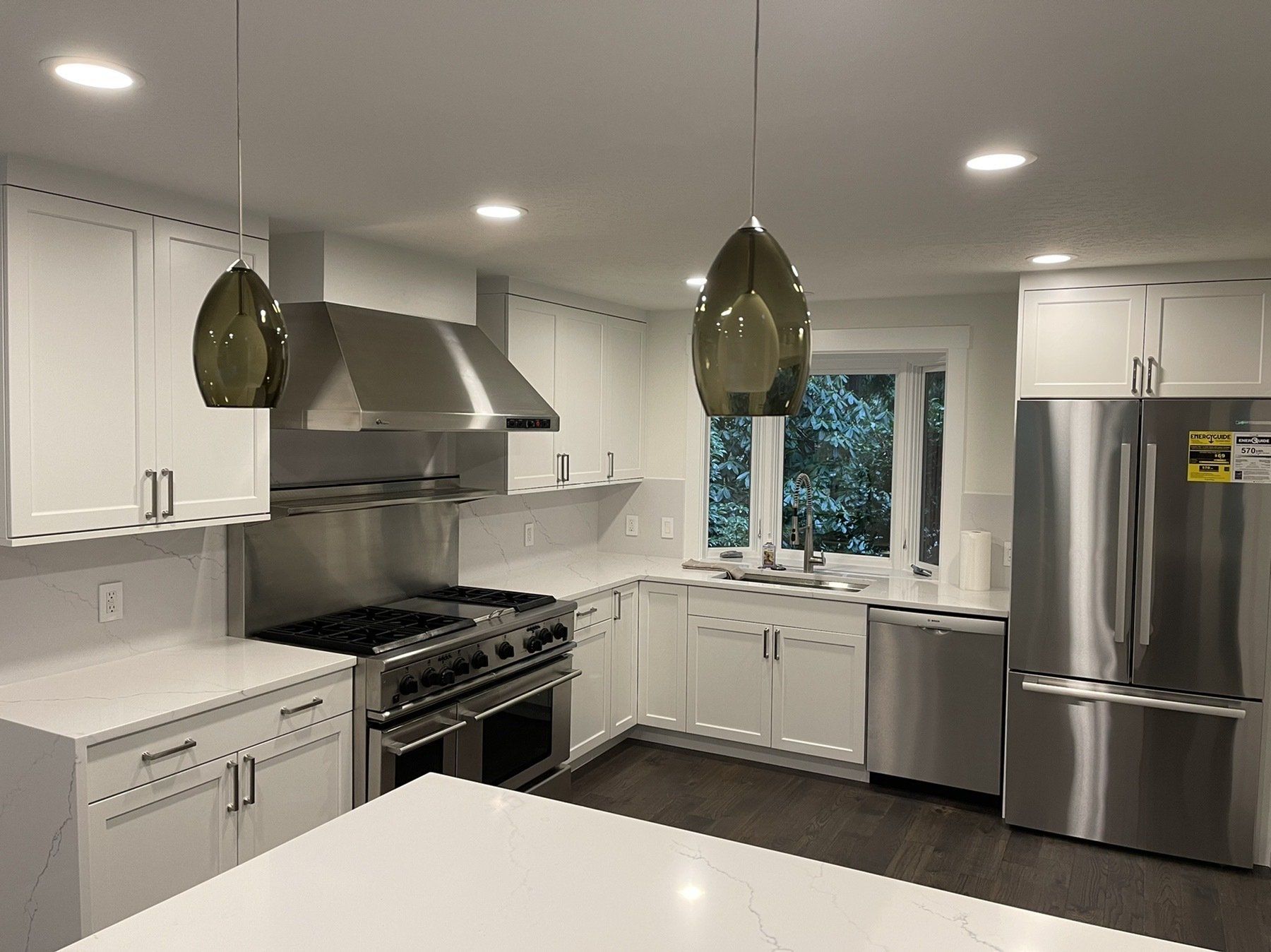A kitchen with stainless steel appliances and white cabinets