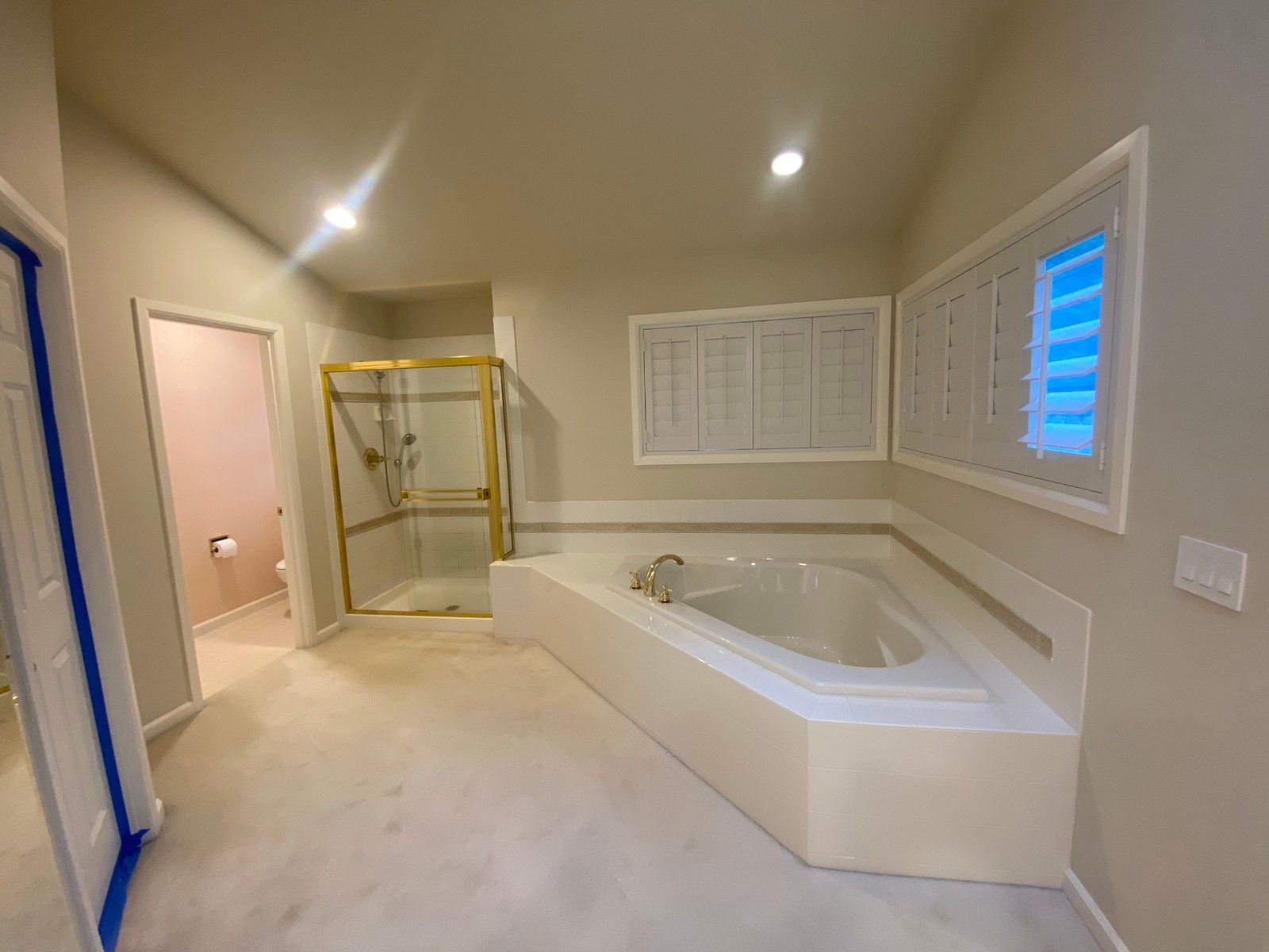A bathroom with a jacuzzi tub and a walk in shower.