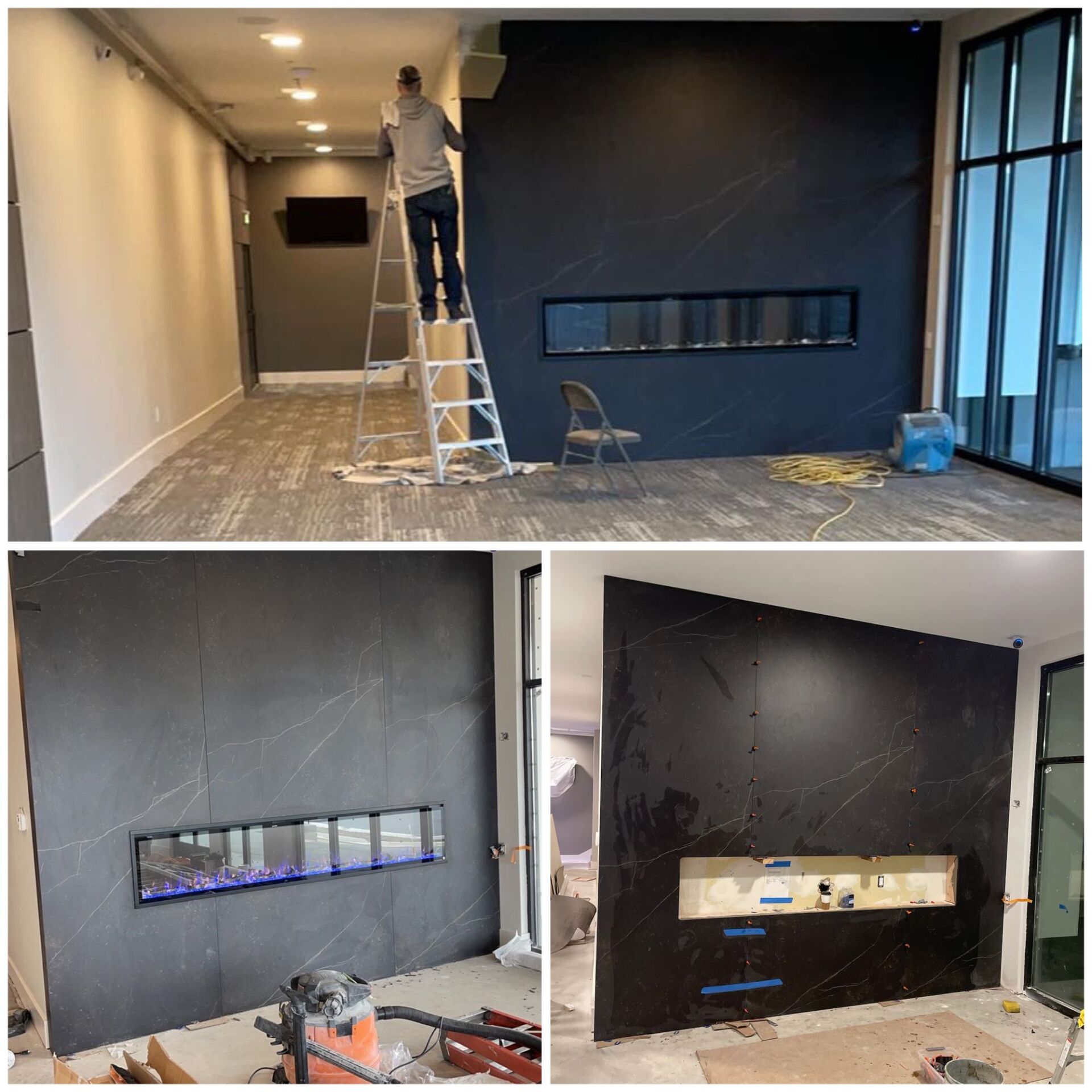 A man on a ladder is painting a wall in a living room.