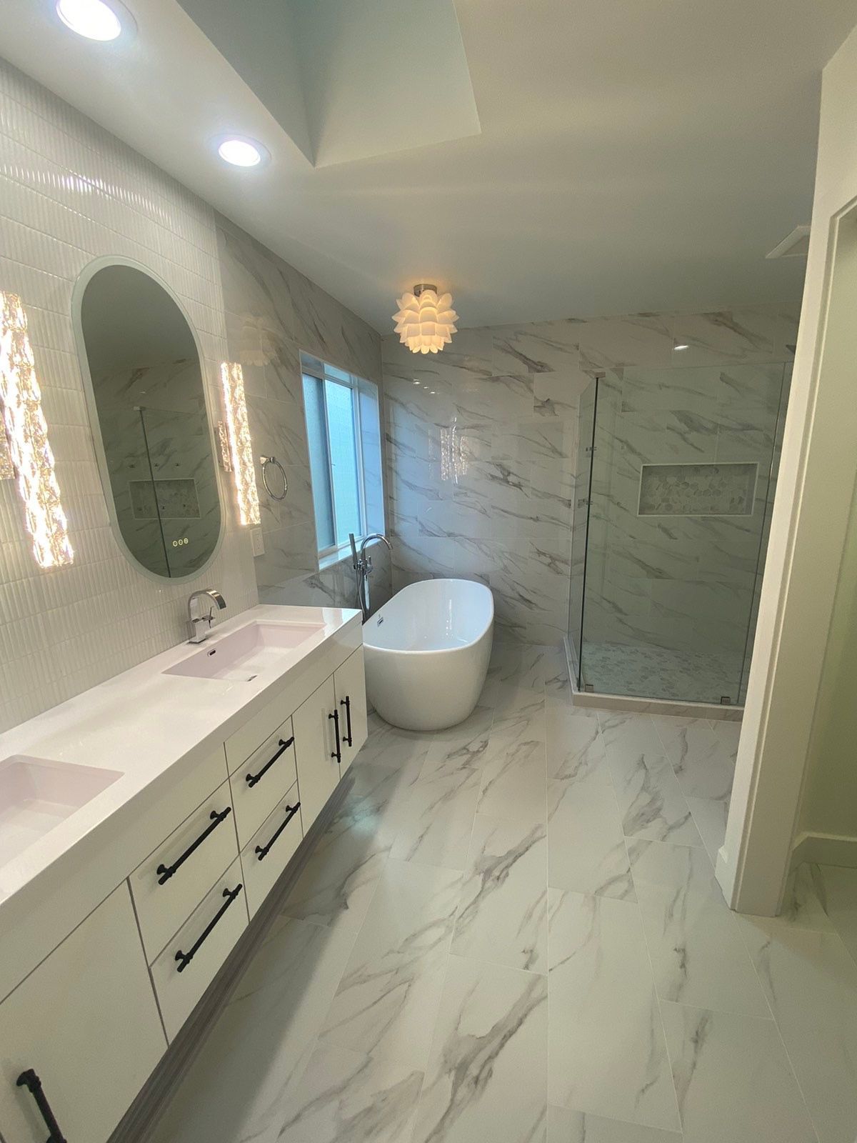 A bathroom with a bathtub , sink , mirror and shower.