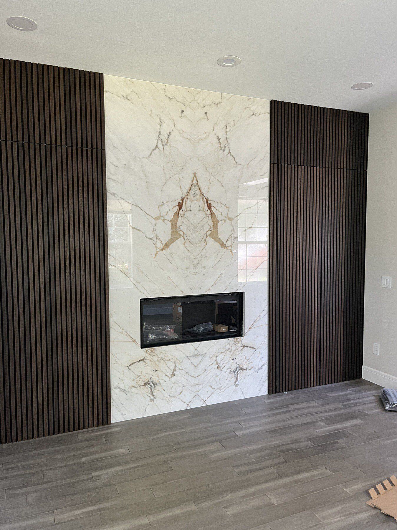 There is a fireplace in the middle of the room.