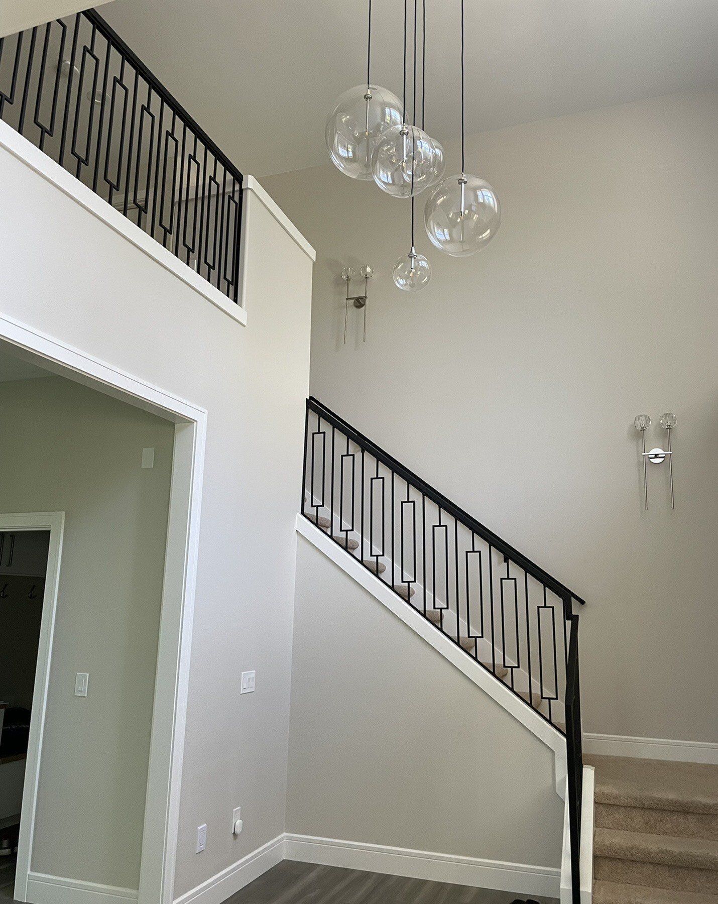 A picture of a staircase in a house with a balcony.