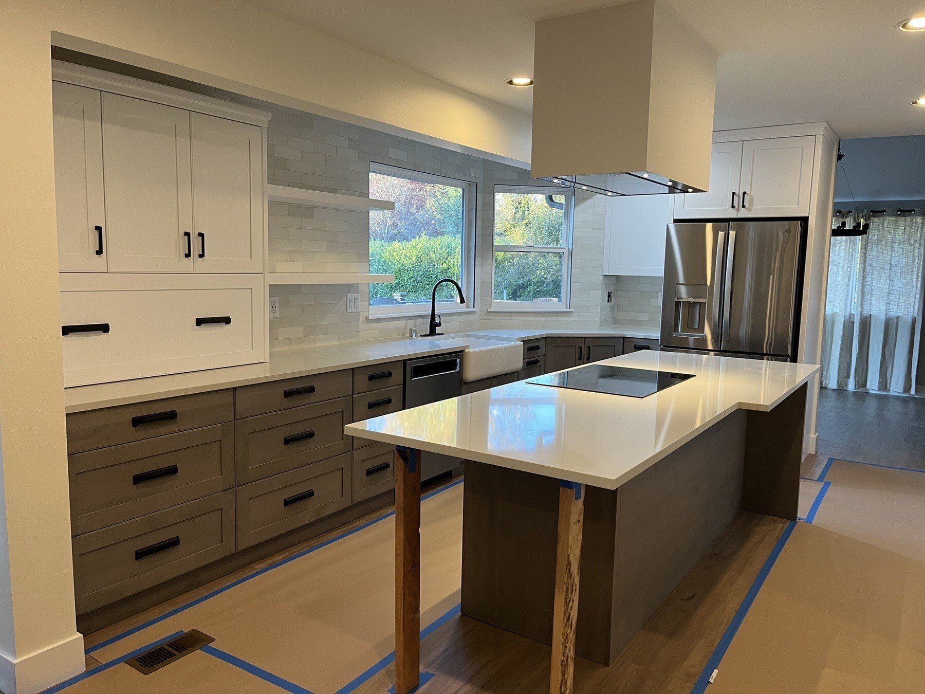 A kitchen with a large island and stainless steel appliances.