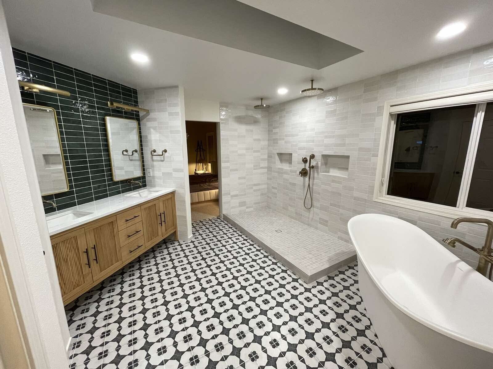 A bathroom with a bathtub , sink and shower.