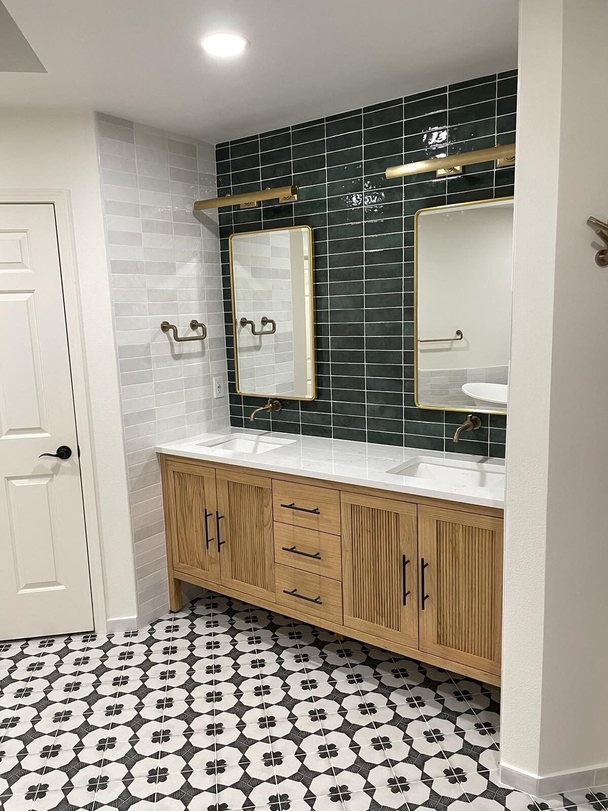 A bathroom with two sinks and two mirrors.