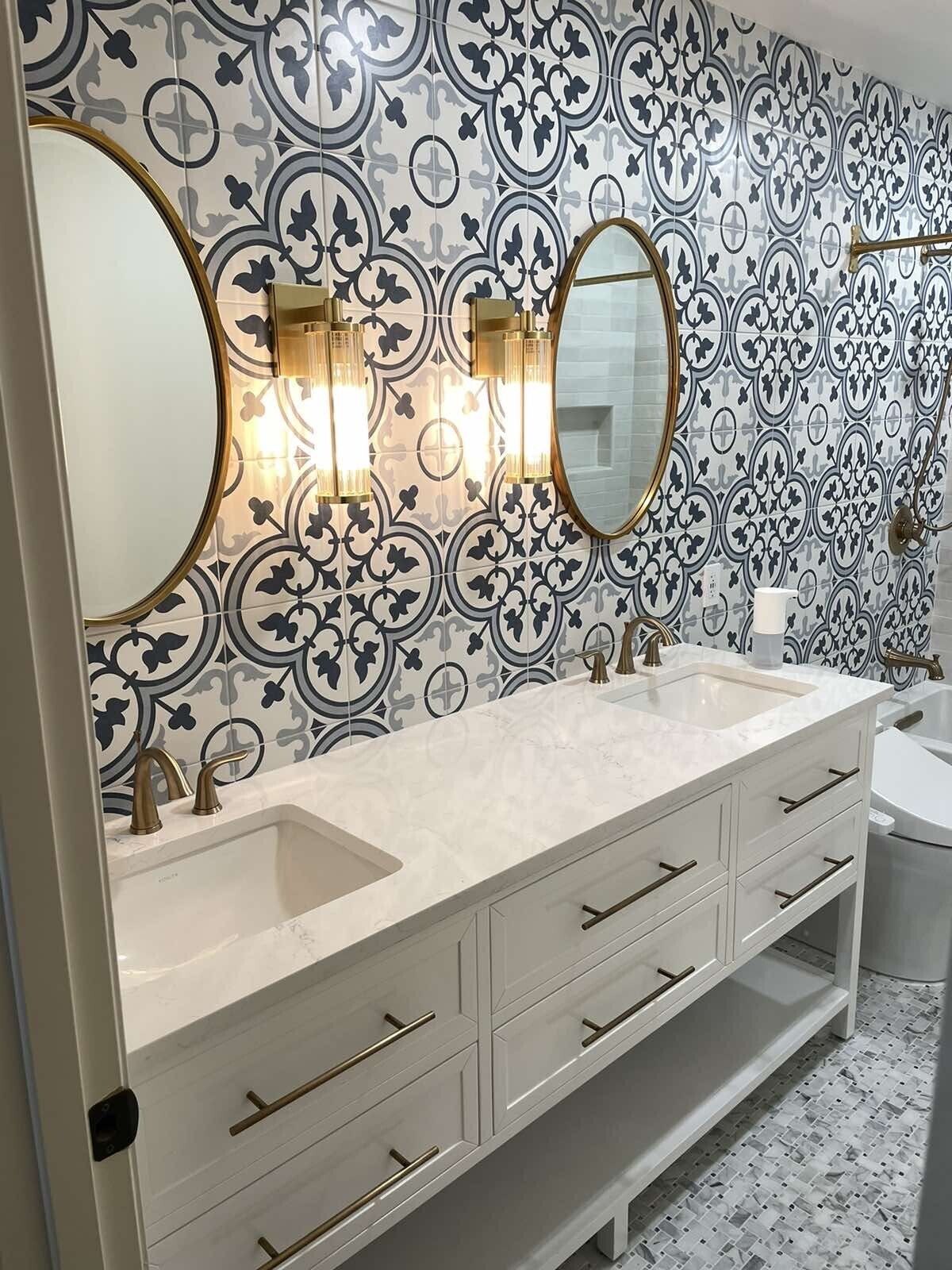 A bathroom with two sinks , two mirrors and a toilet.