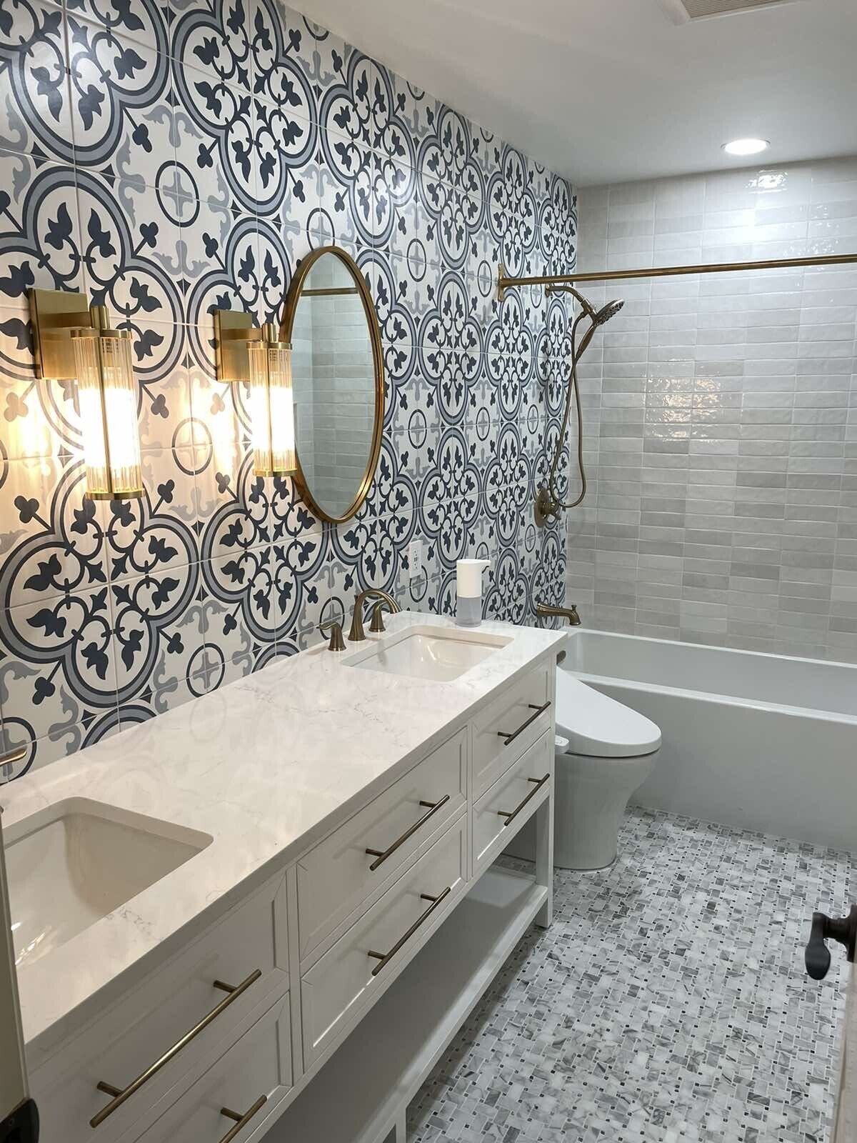 A bathroom with two sinks , a toilet , and a bathtub.