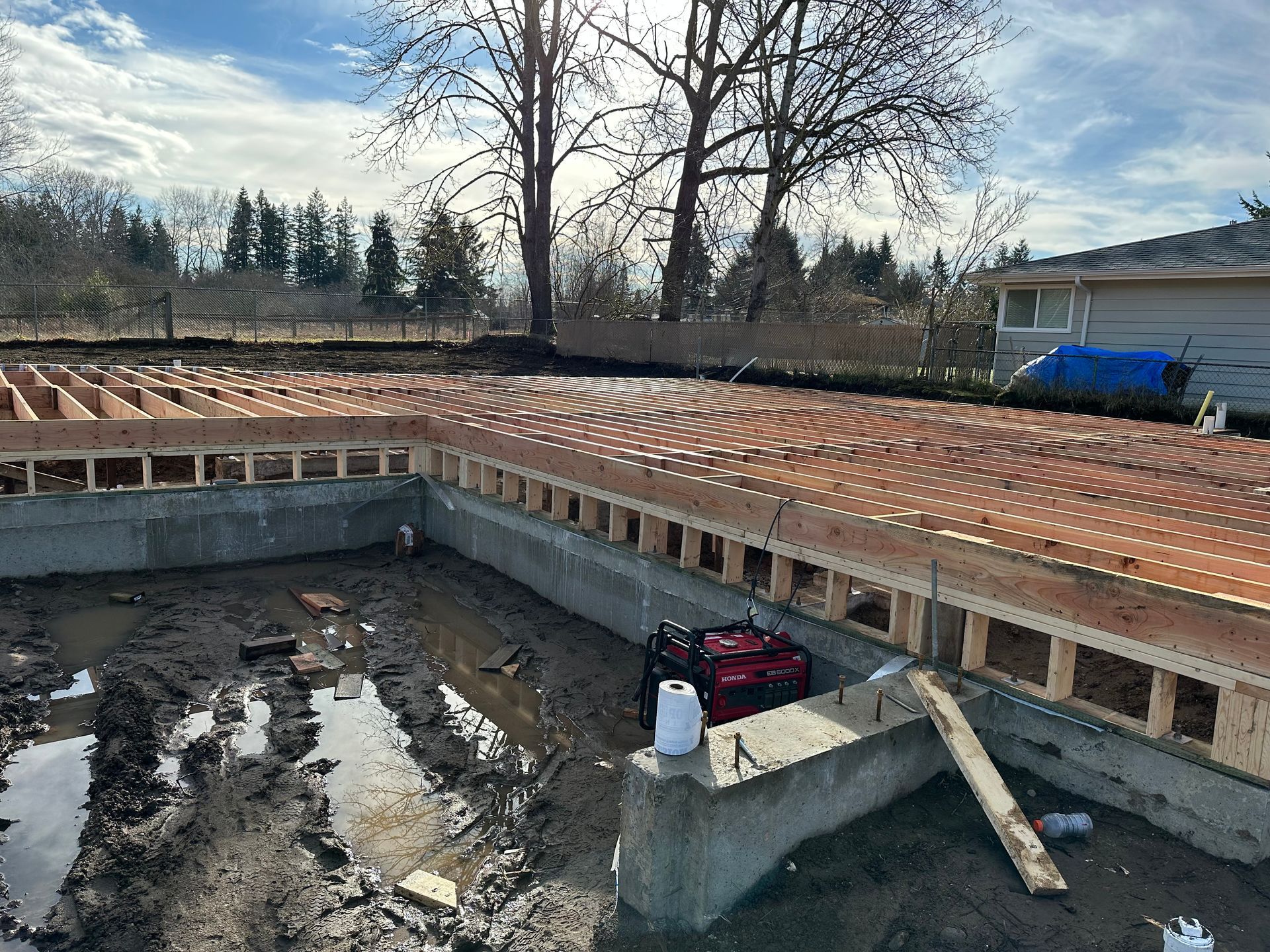 The foundation of a house is being built in the mud.