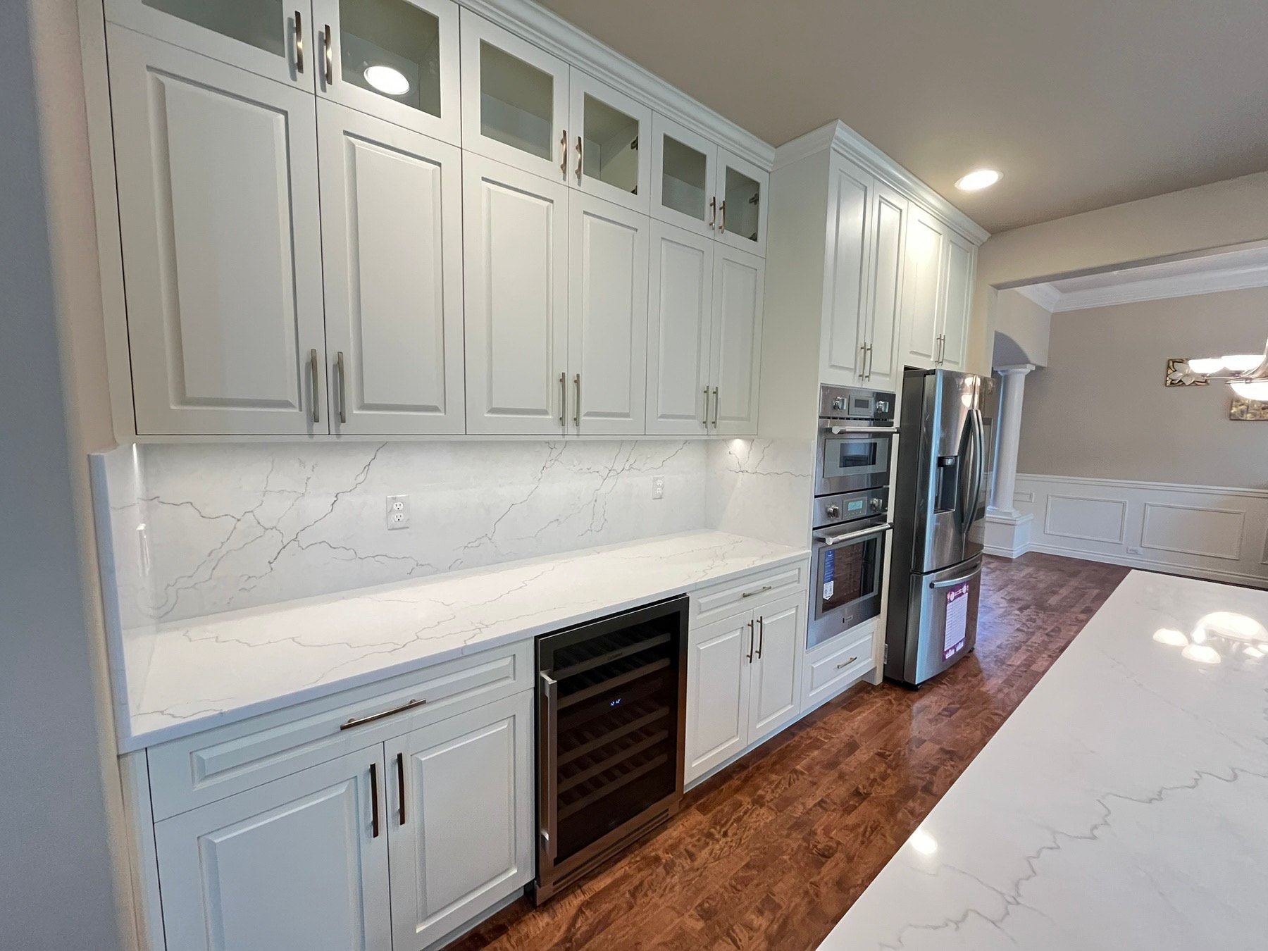 A kitchen with white cabinets and stainless steel appliances.