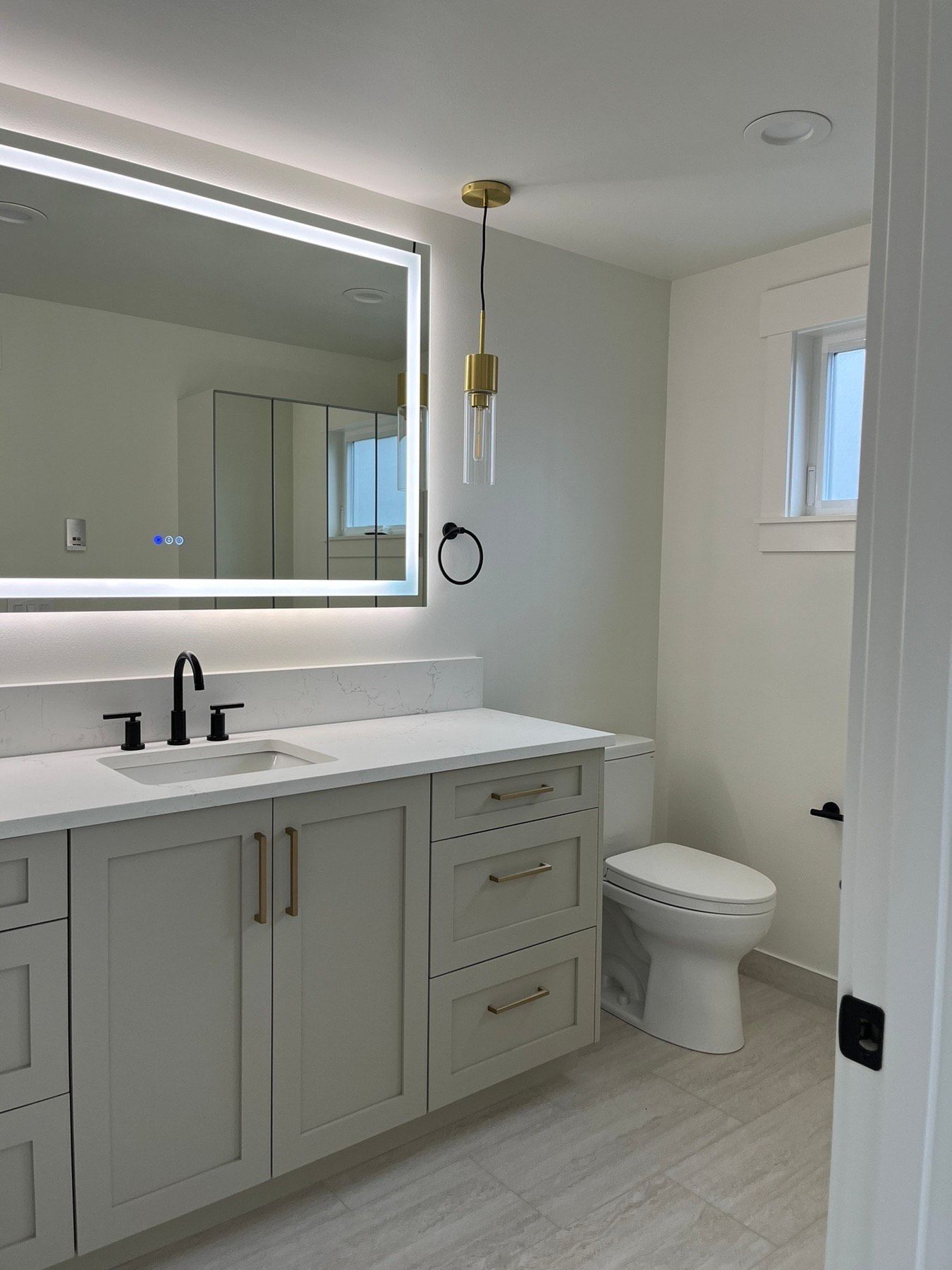 A bathroom with a sink , toilet and mirror.