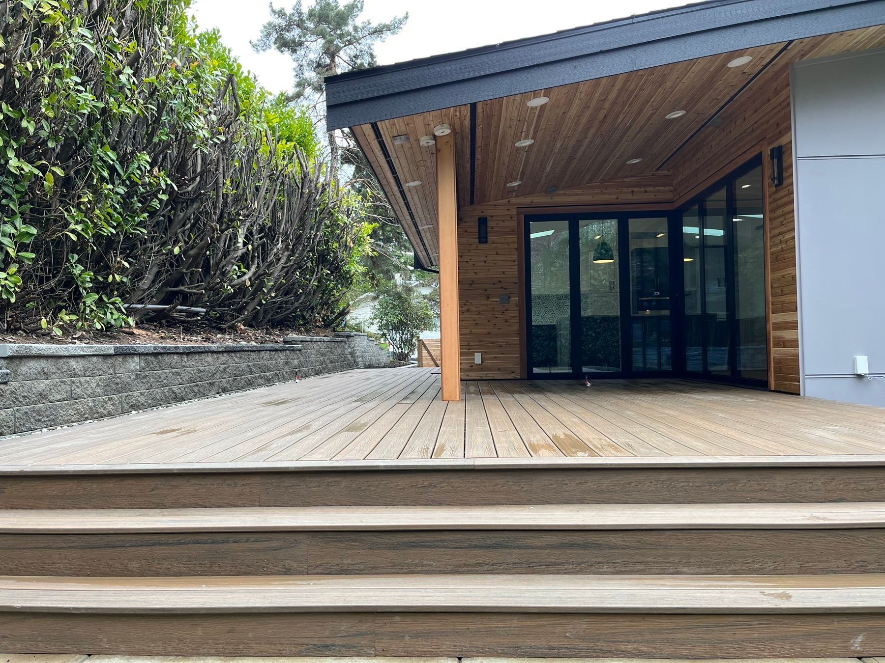 A house with a wooden deck and stairs leading up to it