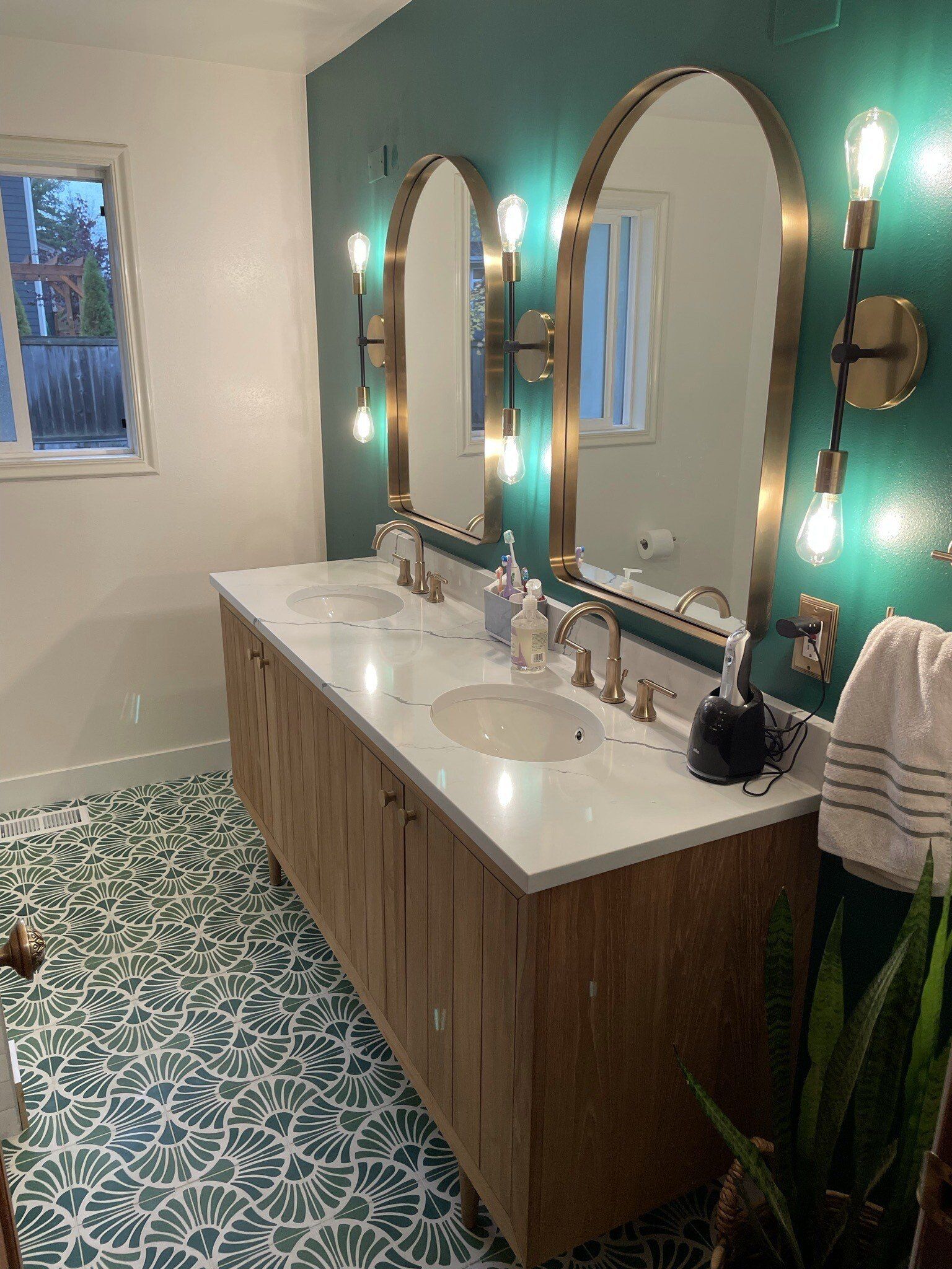 A bathroom with two sinks and two mirrors.