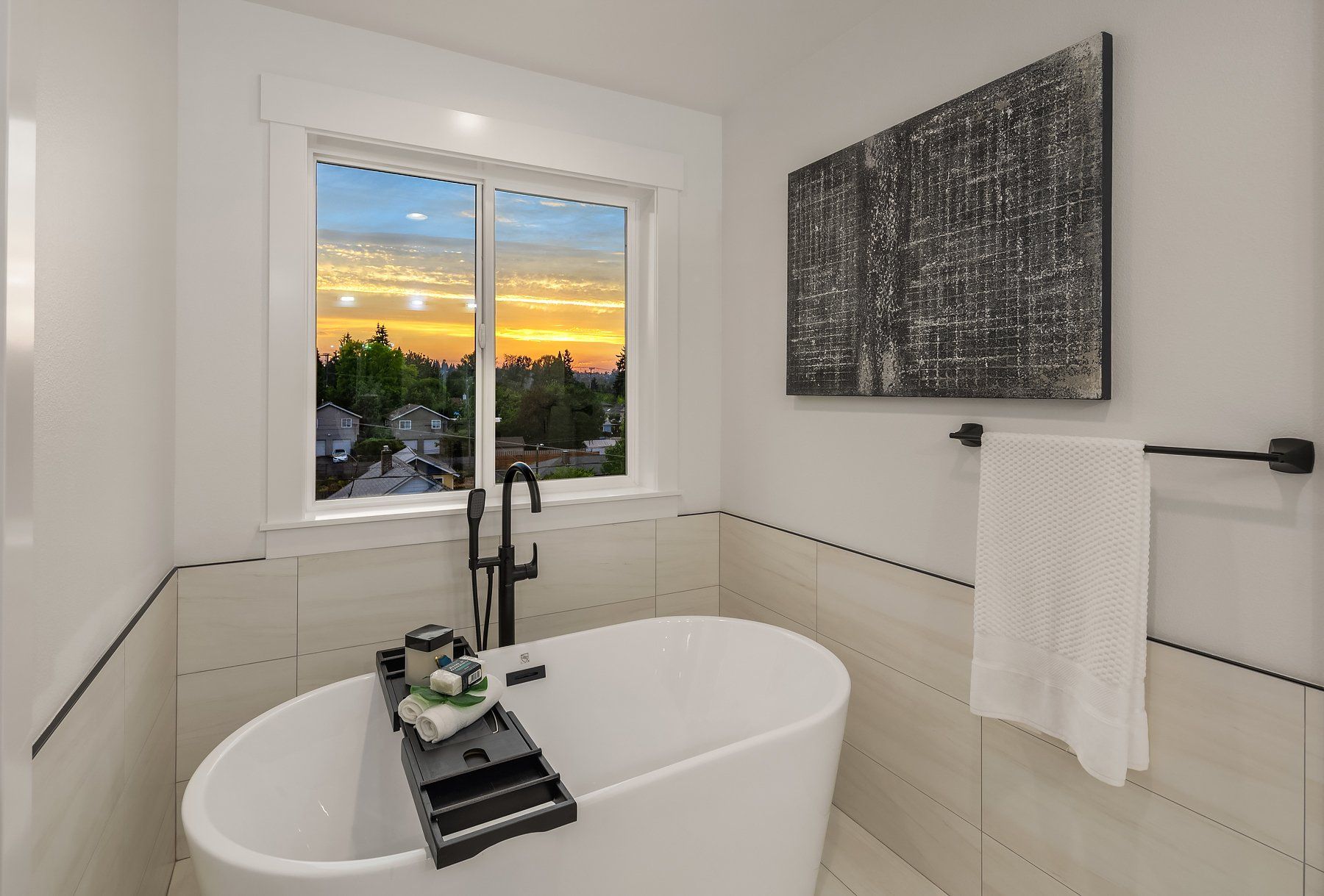A bathroom with a bathtub and a window.