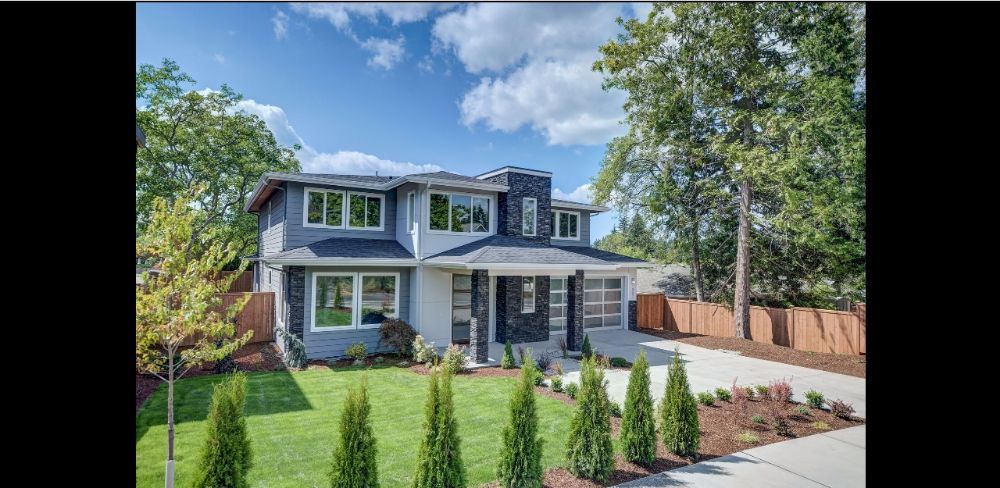A large house with a lot of windows and trees in front of it.