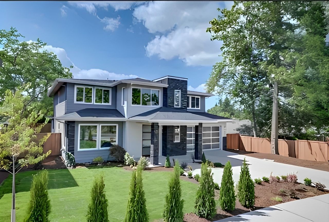A large house with a lot of windows and trees in front of it.