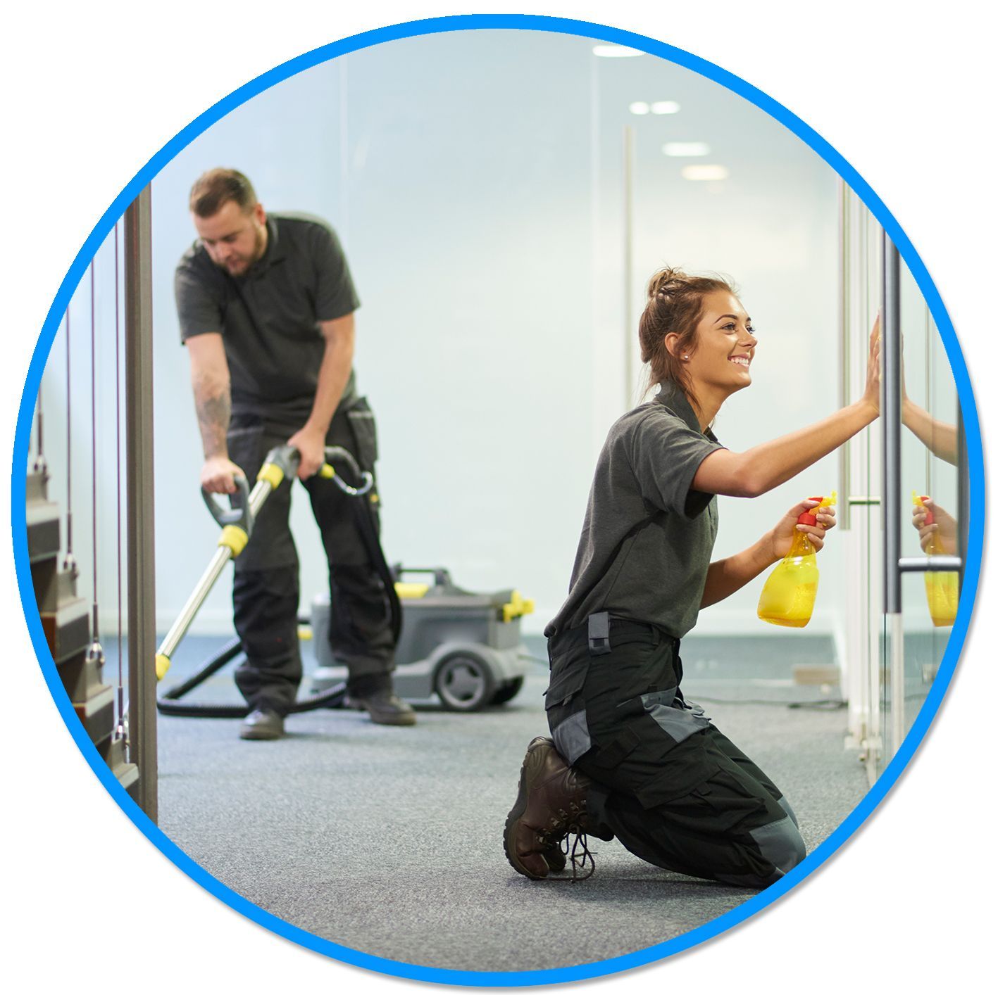 A woman is kneeling down while a man is cleaning a window with a vacuum cleaner