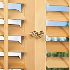 A close up of a pair of wooden shutters on a window.