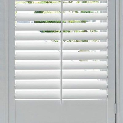 A close up of a white shutter on a window.