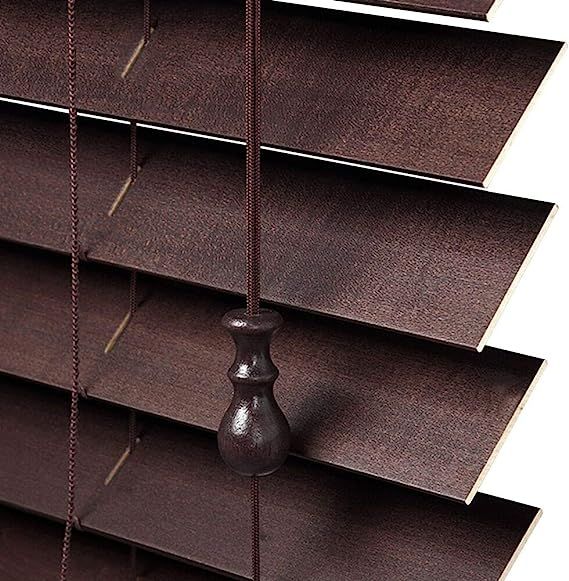 A close up of a brown blind with a wooden handle