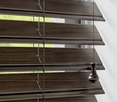 A close up of a wooden blind on a window.