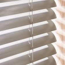 A close up of a wooden blind on a window.