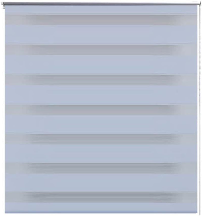 A close up of a zebra blind on a window on a white background.