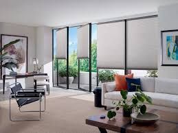 A living room with a couch , chair , table and sliding glass doors.