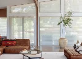 A living room with a couch , table , and potted plant.