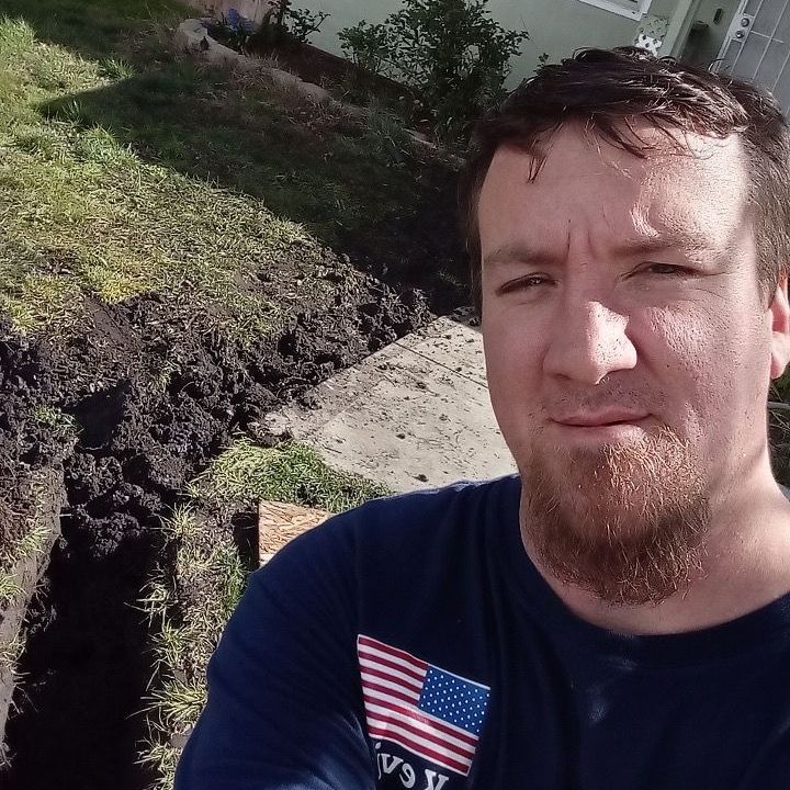 A man wearing a hat with a bull on it