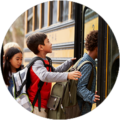 A group of children are boarding a school bus.