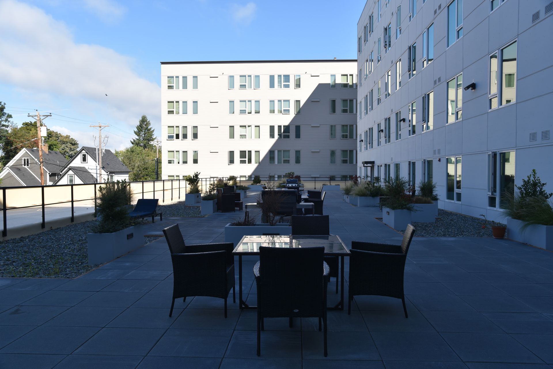 photo showing courtyard area with the building casting a shadow over