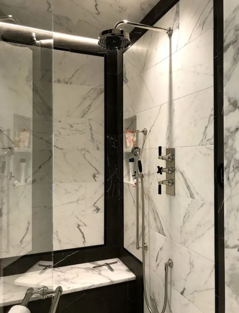 A marble ceiling with a square mirror in the middle