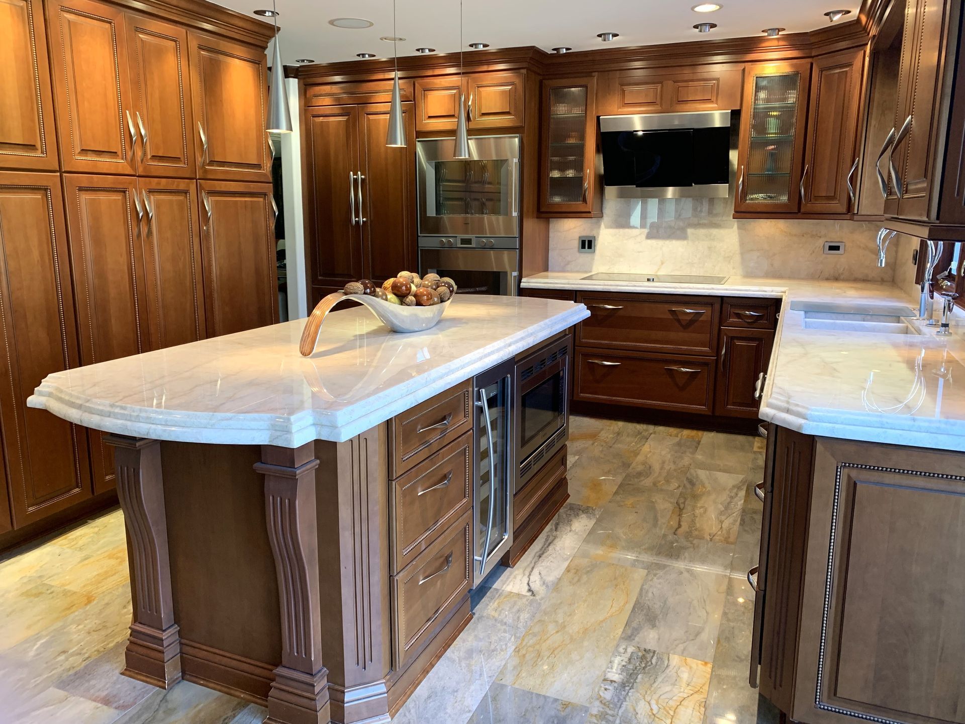 A kitchen counter with a bowl of fruit on it