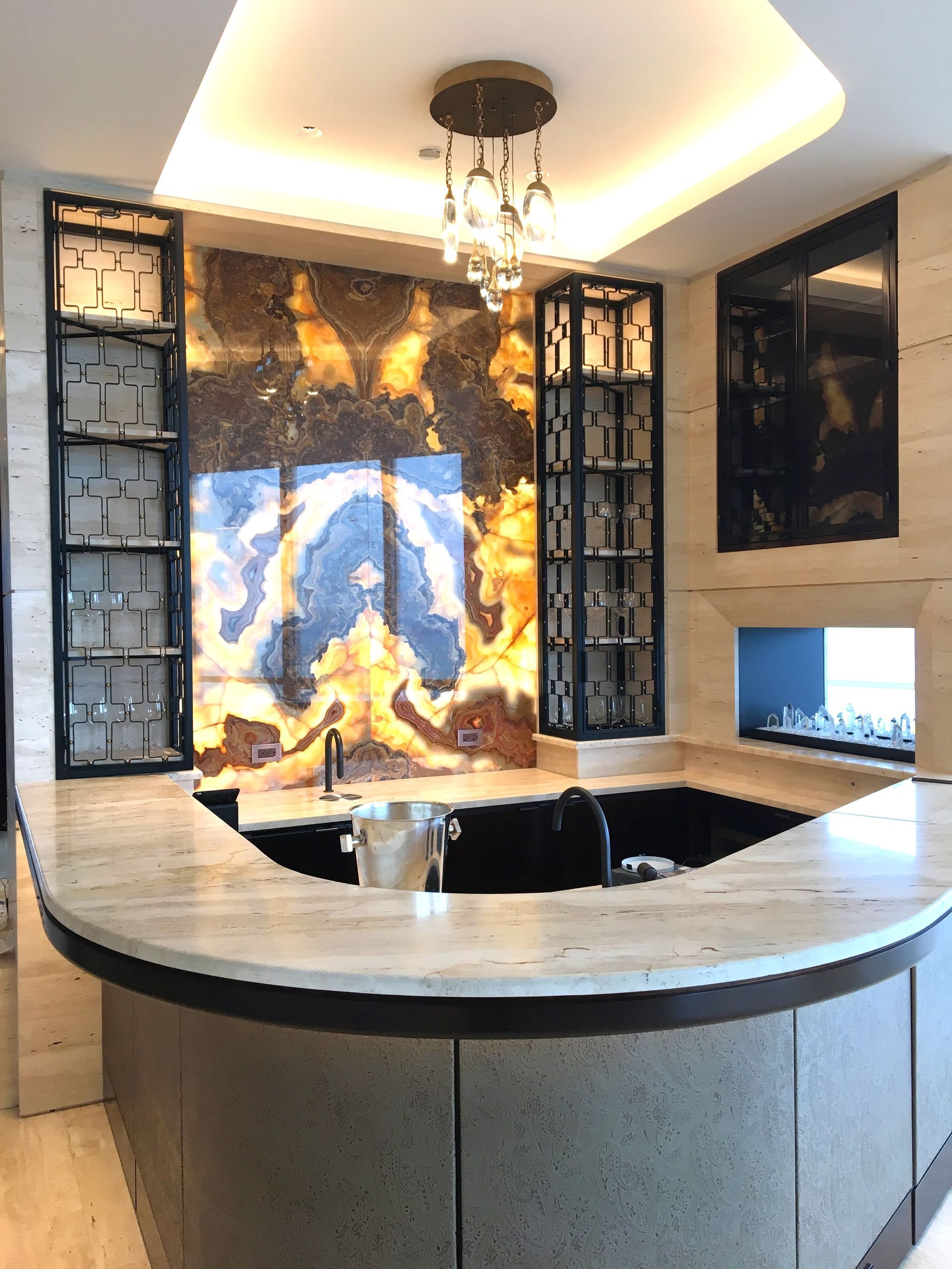 A kitchen with a large island and a stove top oven.