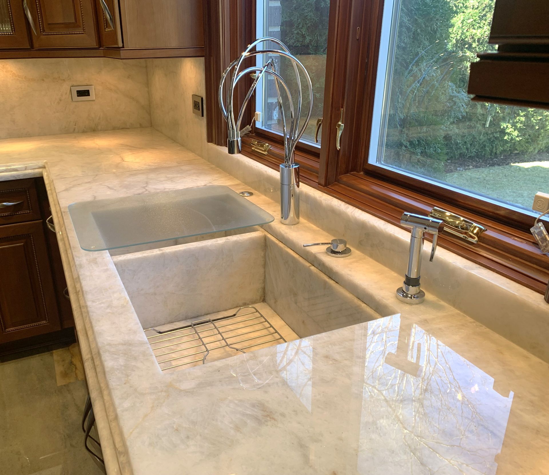 A kitchen with two sinks and a window