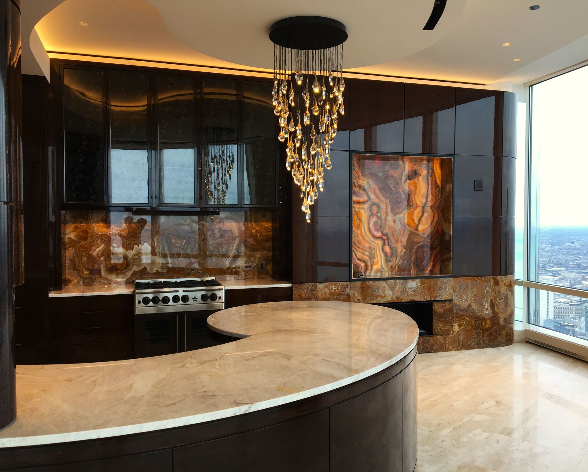 A kitchen with white cabinets and a large island in the middle.