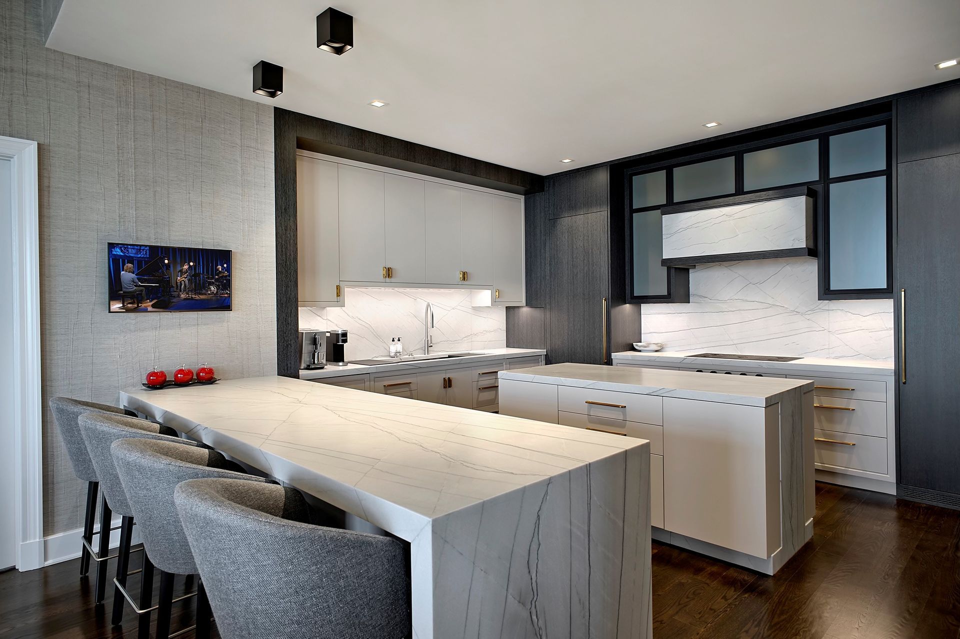 A bowl of fruit sits on a counter in a kitchen