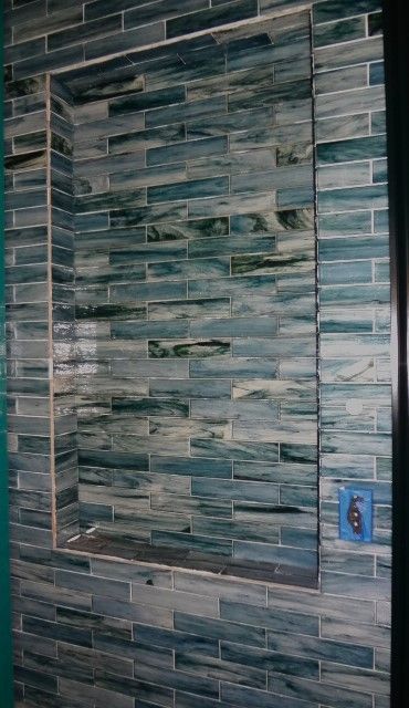 A brick wall with a niche in the middle of it