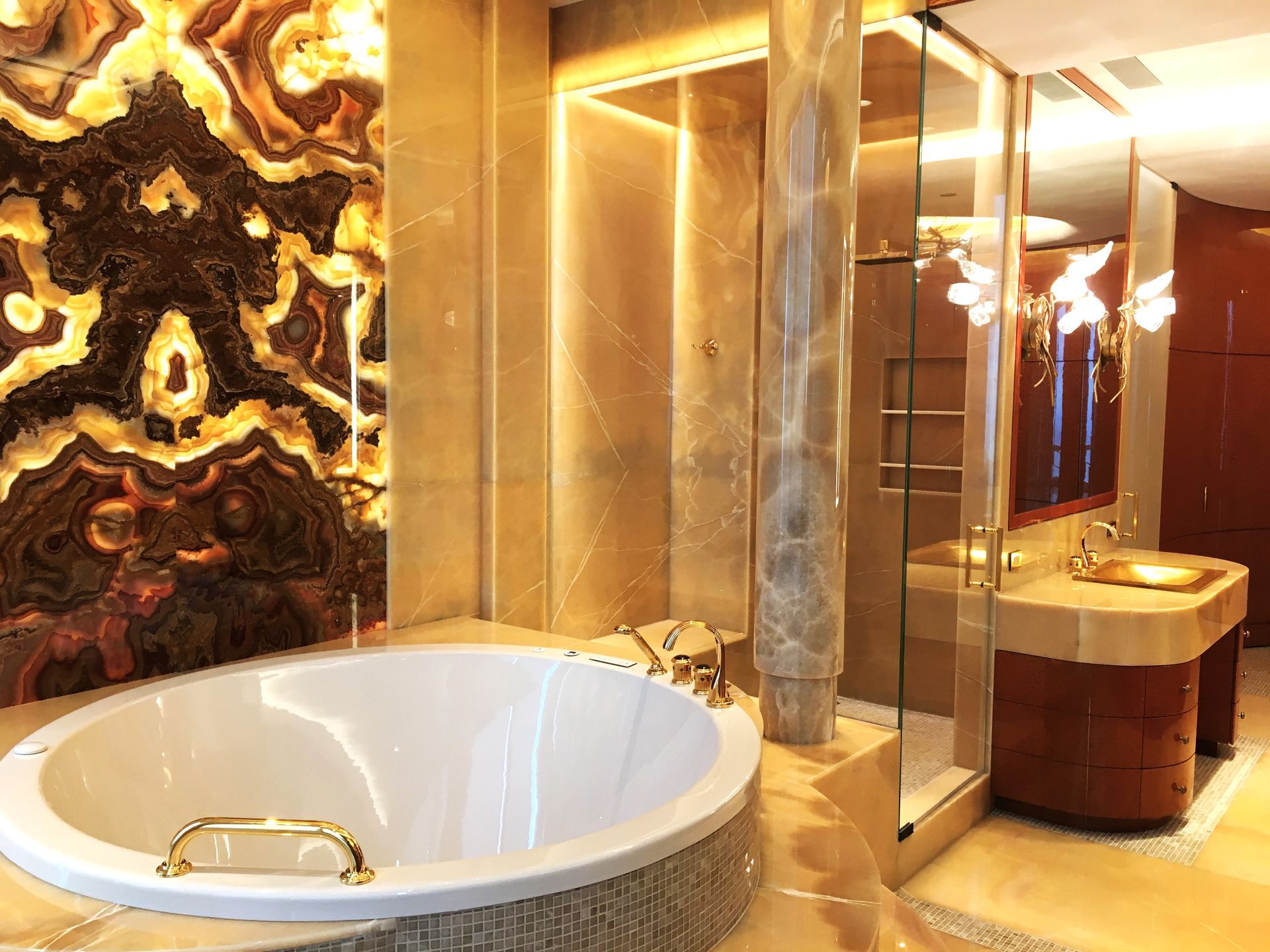 A bathroom with a mirror and a lamp on the wall.