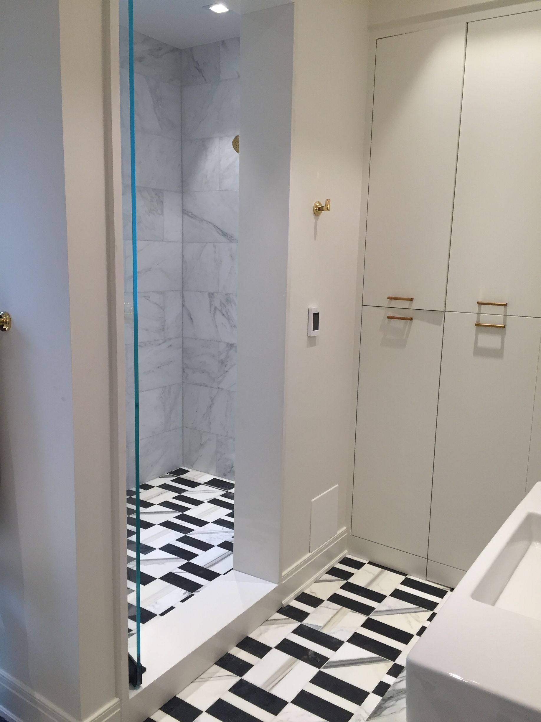 A bathroom with a black and white checkered floor