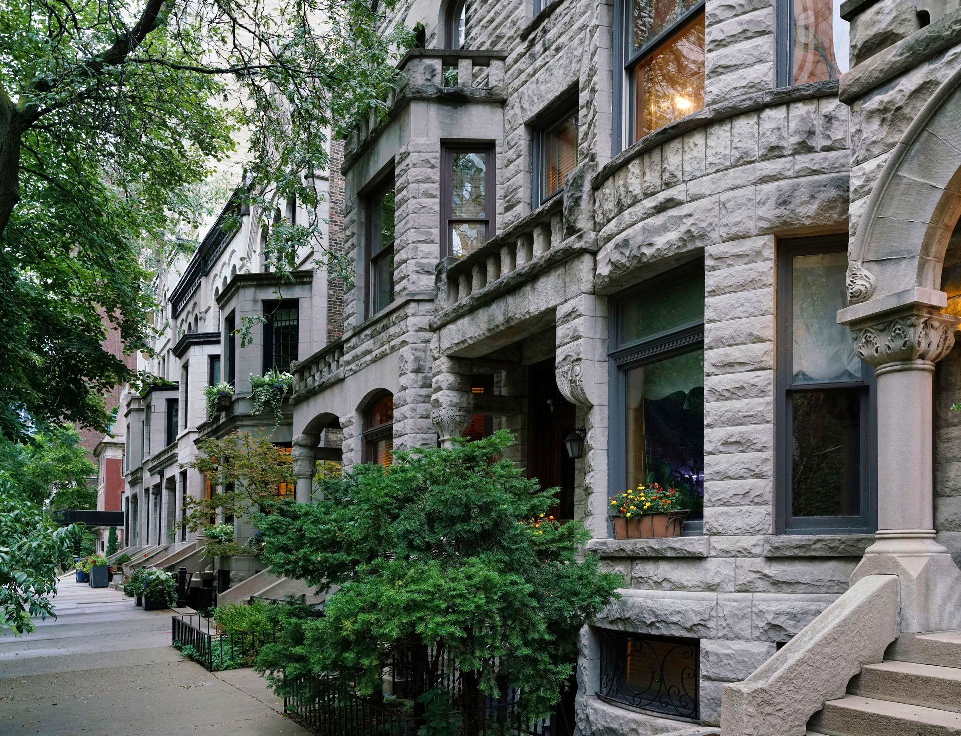 A large brick house with a lush green lawn in front of it.